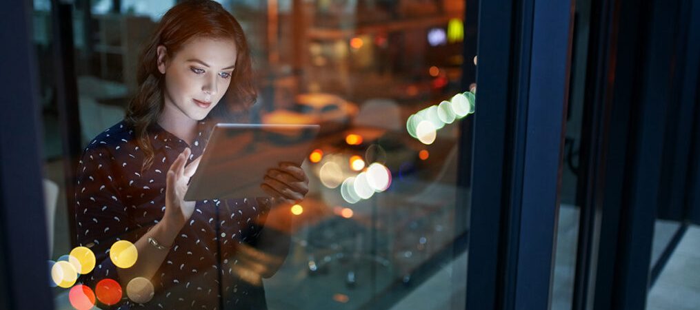 Cropped shot of a young businesswoman working late on a digital tablet in an office